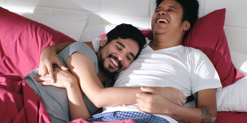 Couple embracing at a bed