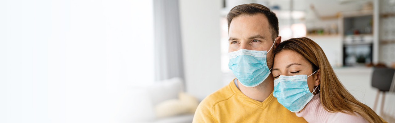 Couple with face masks at home
